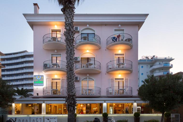 a large white building with people on the balconies at Il Lauro in San Benedetto del Tronto