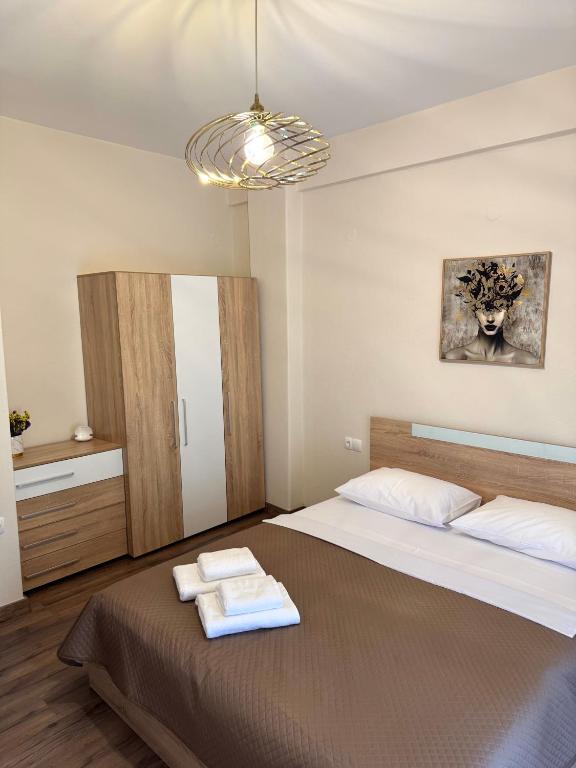 a bedroom with a bed with two towels on it at Nikoletta in Katerini