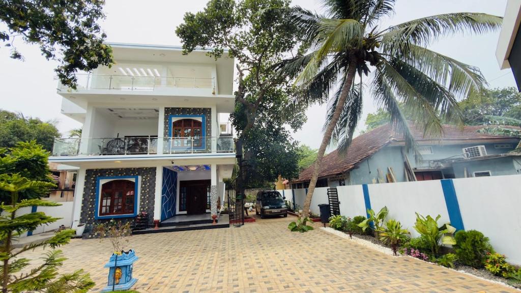 a house with a palm tree in front of it at A&T villa in Jaffna