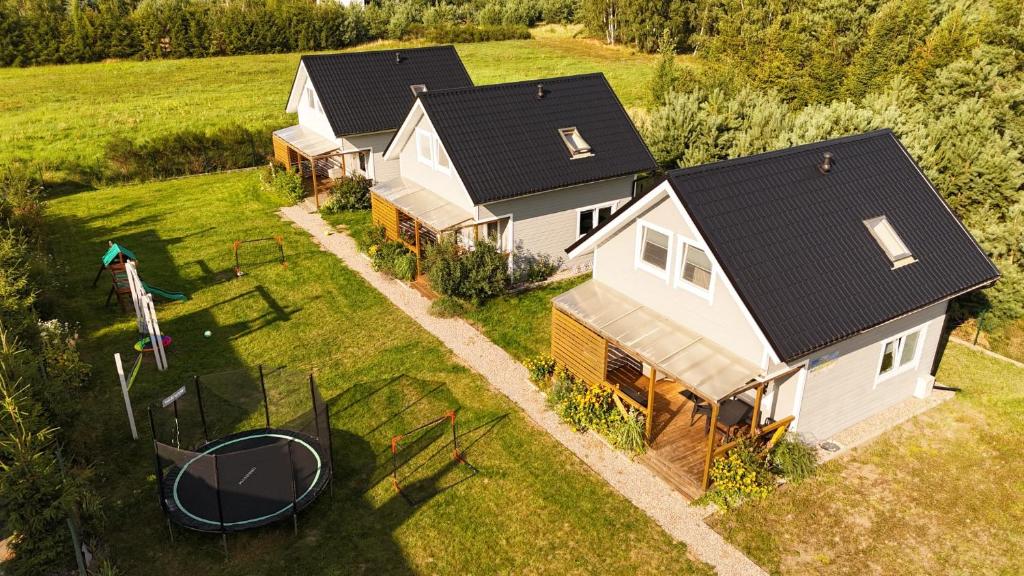 an aerial view of a house with a trampoline at Domki Poczekajka in Sasino