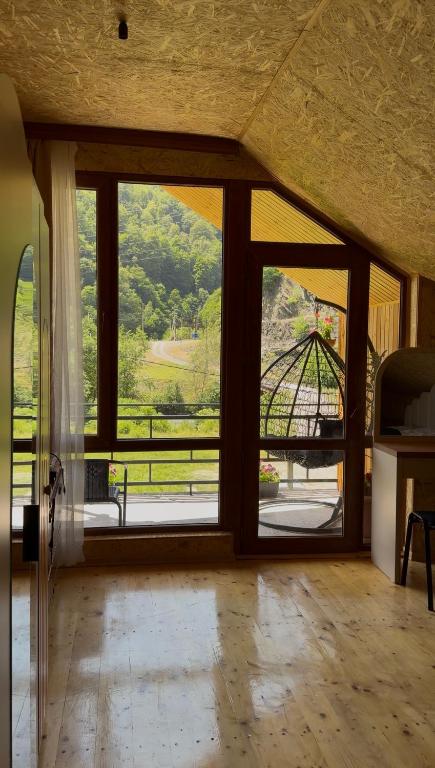 a room with a large window with a view of a view at Guesthouse Riverside Bagiana in Roshka