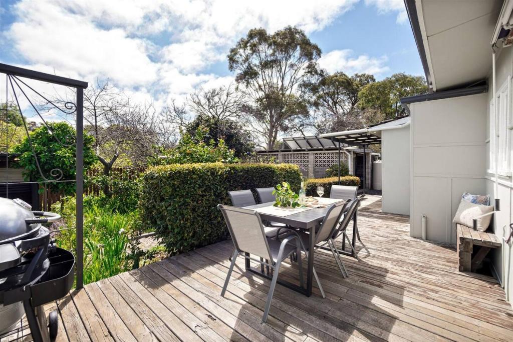 a patio with a table and chairs on a deck at Elva Garden Cottage - Dog Friendly - Town Central in Margaret River Town