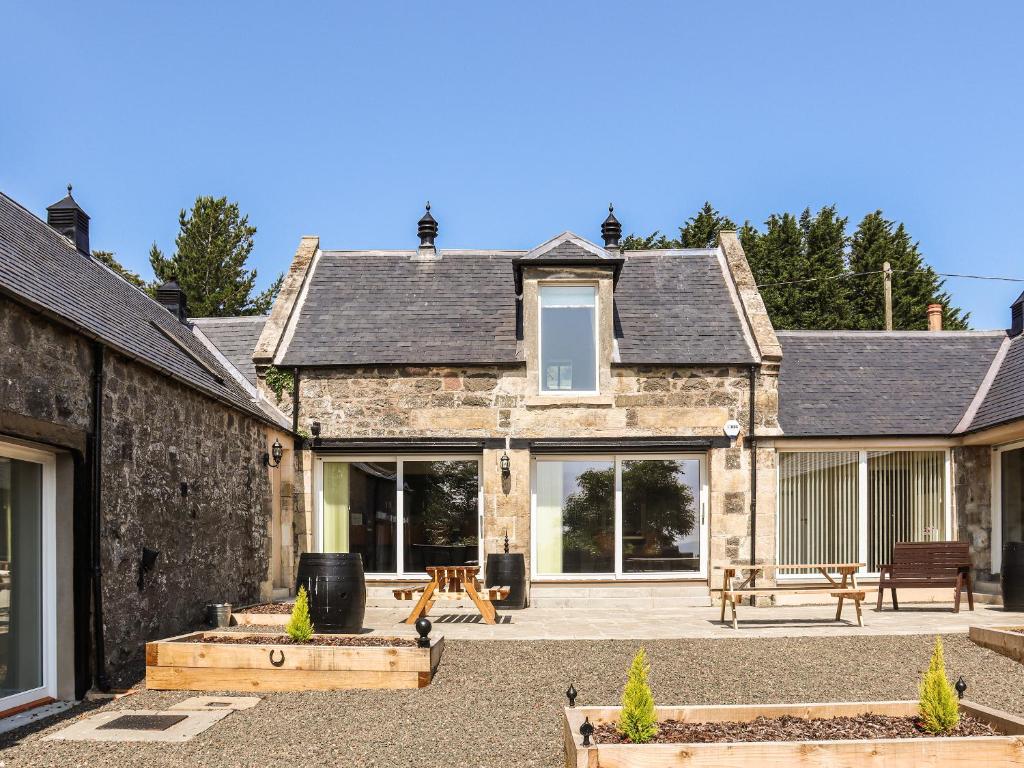 an external view of a house with a patio at The Coach House in Auchtermuchty