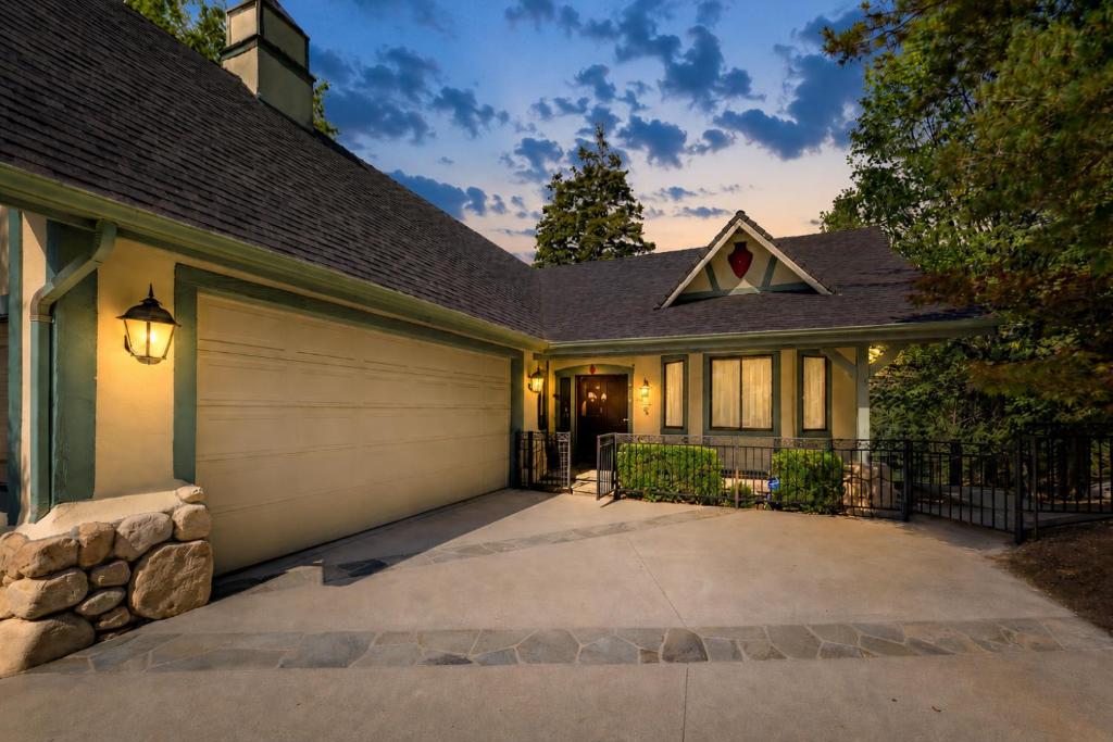 a house with a garage and a driveway at Emerald Oasis in Lake Arrowhead