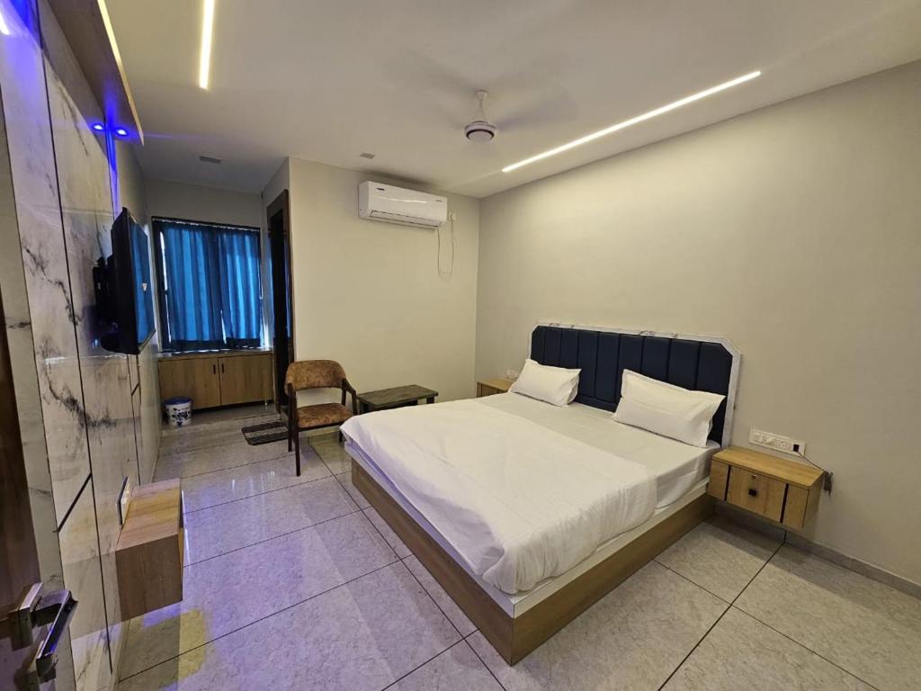 a bedroom with a bed and a tv in it at Hotel Shiv Inn in Himatnagar