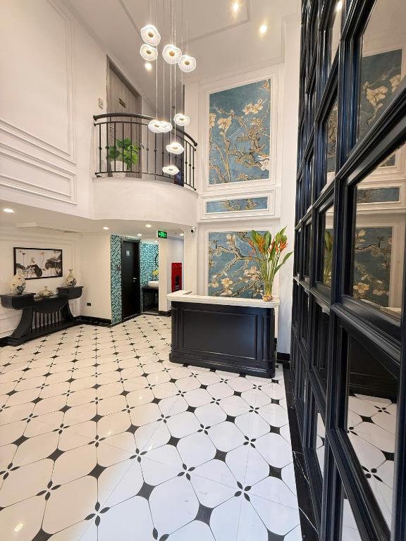 a large room with a white and black tiled floor at Hanoi Citadel Corner in Hanoi