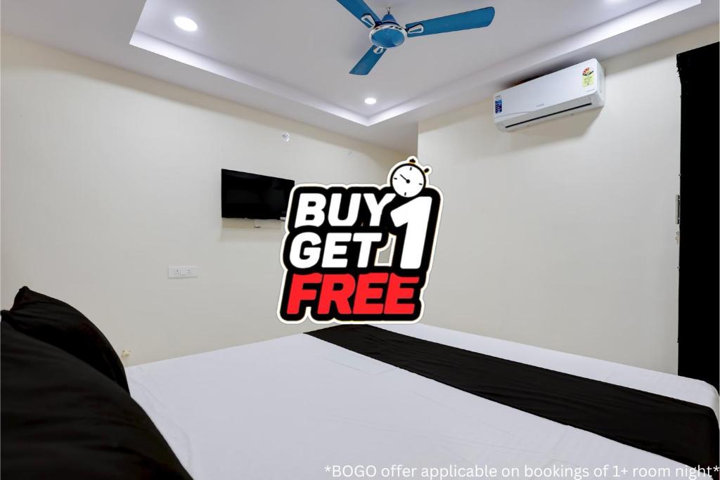 a bedroom with a buy get free sign on the wall at Hotel O Madurawada Formerly IT Sez in Visakhapatnam