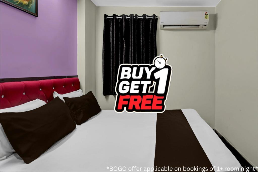 a bedroom with a bed with a buy sign on it at Hotel O Visakhapatnam Railway Junction Formerly Kesava Residency in Visakhapatnam