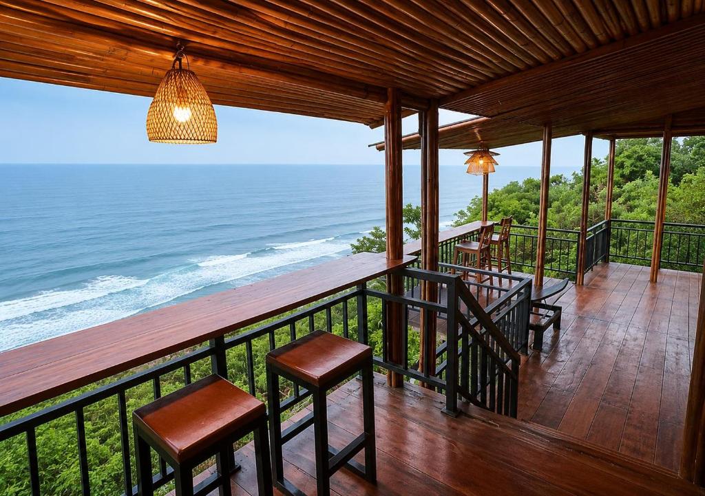 a balcony with a view of the ocean at Nunggalan Octopus 2 in Uluwatu