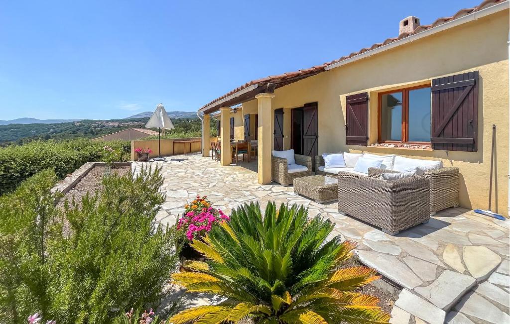 a villa with a patio and a house at Villa Pisicne in Mons