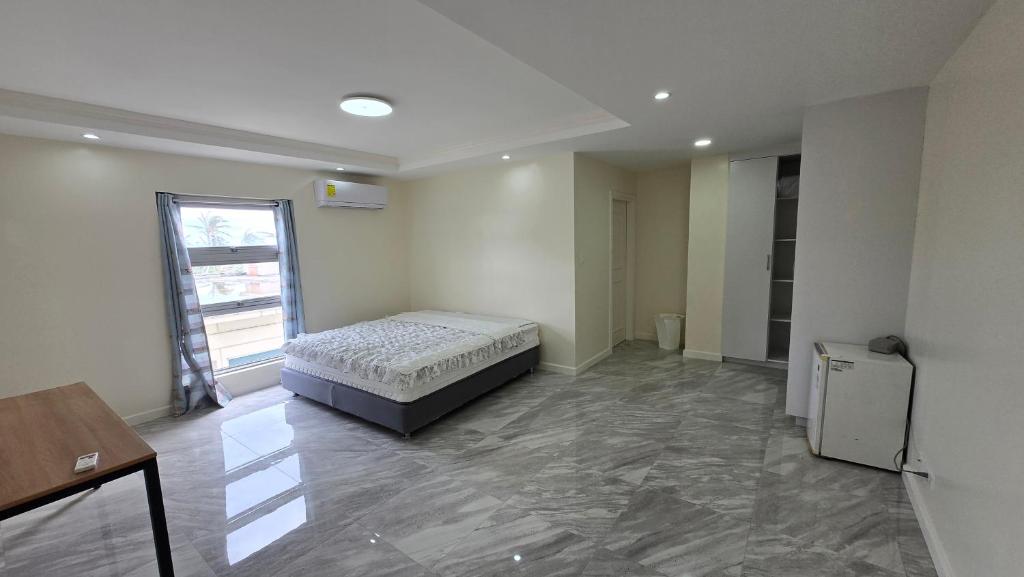 a bedroom with a bed in the middle of a room at Beachfront House in Garapan
