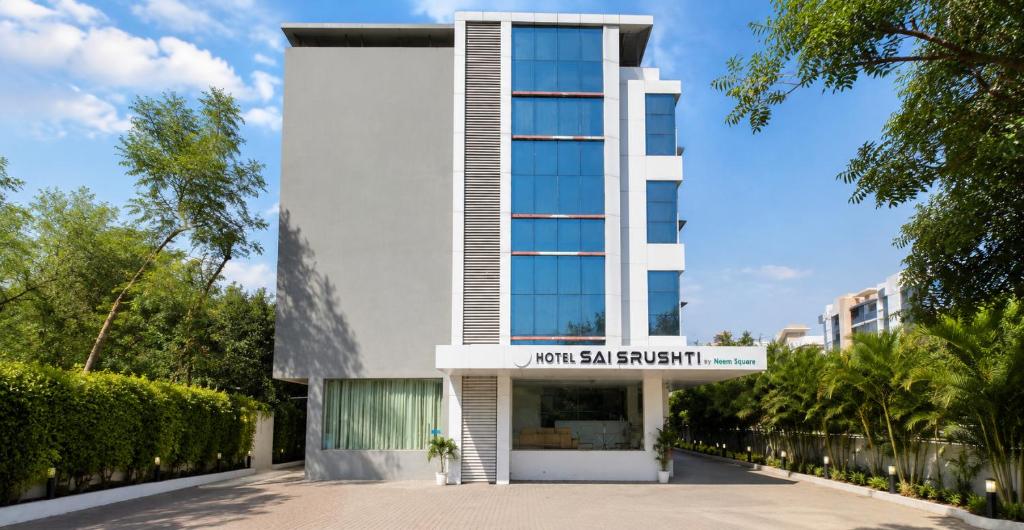 a building with a sign that reads walk san elephant at SAI SRUSHTI by NEEM SQUARRE in Shirdi