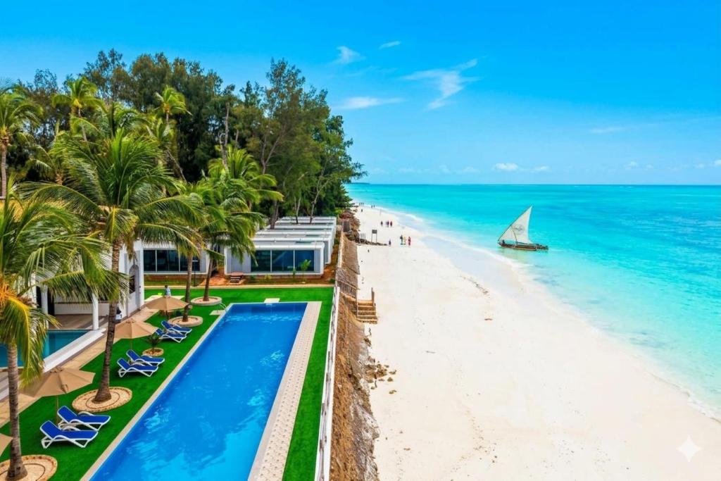 a resort with a beach and a swimming pool at Sea Side Resort in Paje