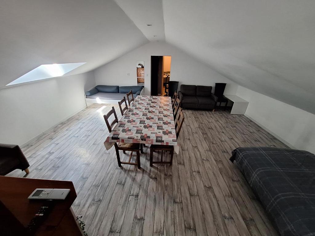 a room with a table and chairs and a couch at Appartement Les 3 L in Vions