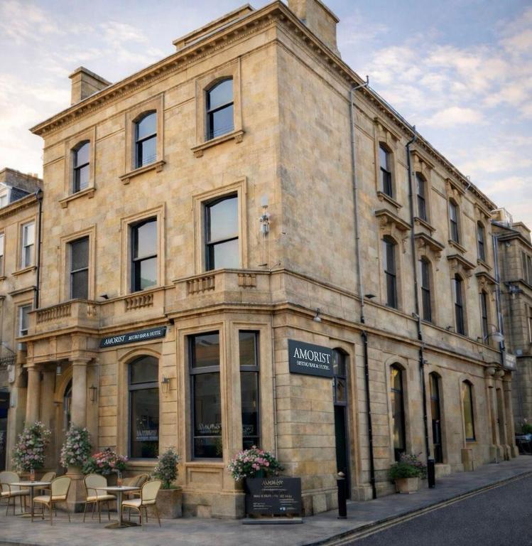 a building with tables and chairs in front of it at Amorist Hotel in Dunfermline