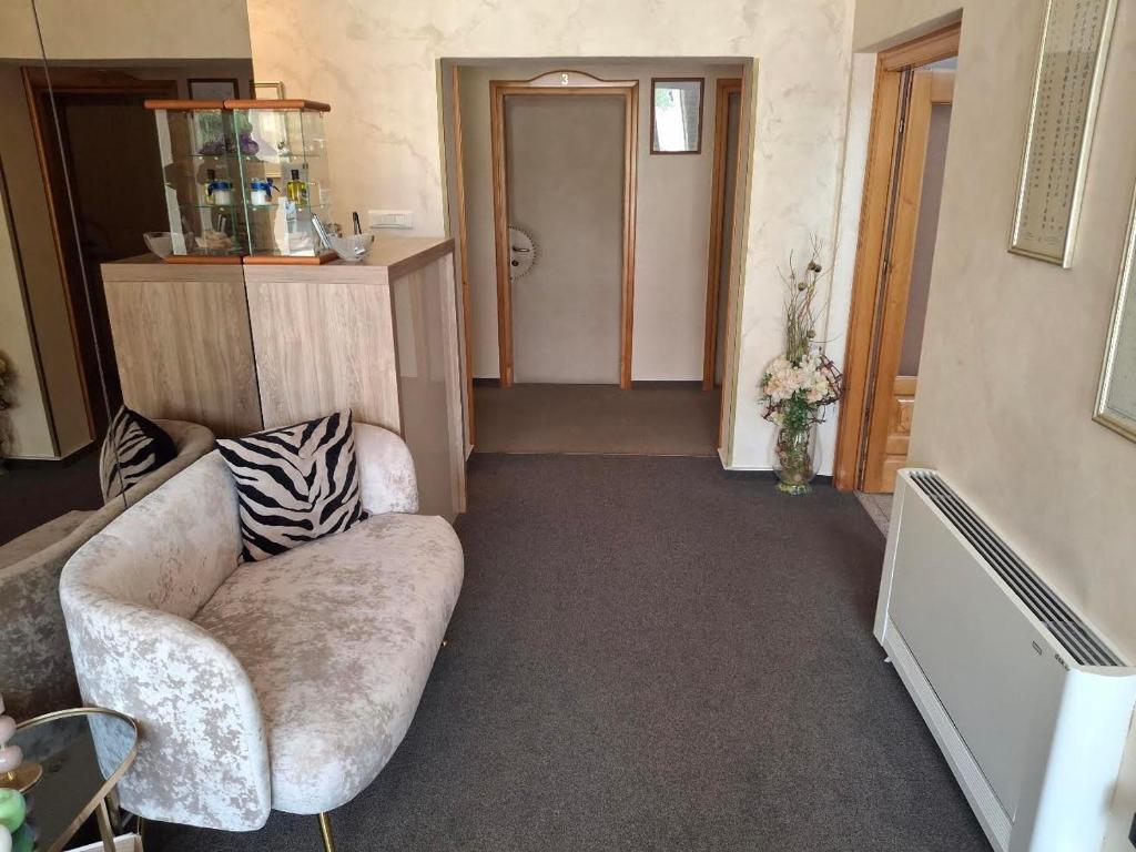 a living room with a couch and a hallway at B&B Vila Milčetić in Malinska