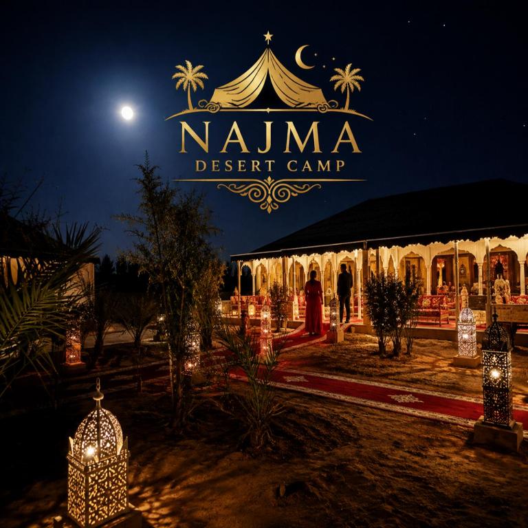 a tent with a sign that reads nuna desert camp at night at Najma Desert Camp in Merzouga