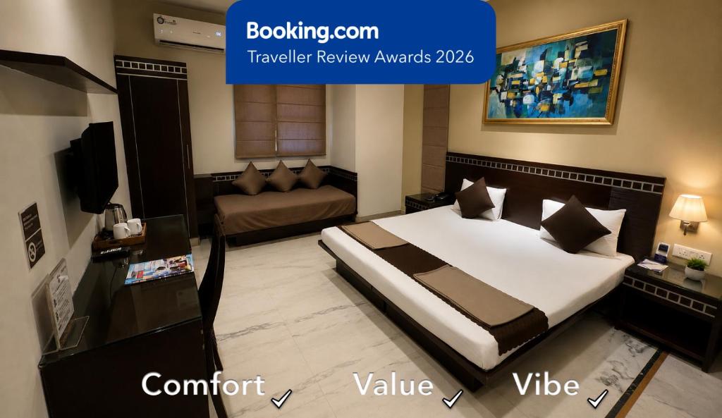 a hotel room with a bed and a couch at Smyle Inn - Comfort & Value near New Delhi Railway Station - since 1998 in New Delhi