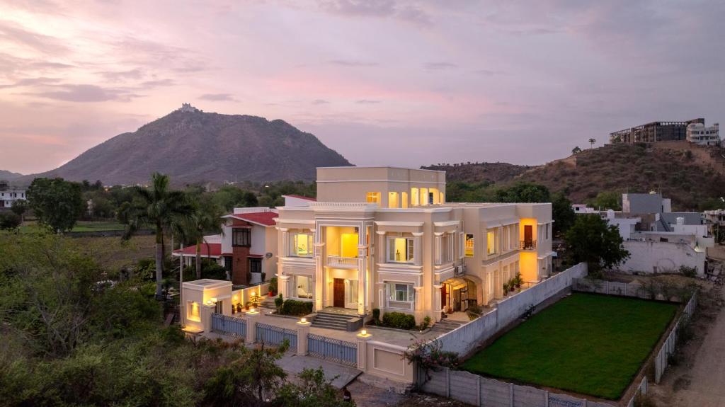 an aerial view of a house with a mountain in the background at Chez Lavania - A Boutique Stay in Udaipur