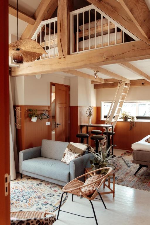 a living room with a couch and a loft at Granny's B&B in Kapelle