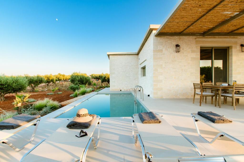 a swimming pool in the backyard of a house at Sky And Stone Private Villa in Kathiana