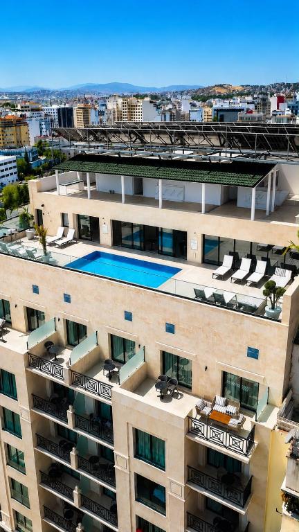 an aerial view of a building with a swimming pool at L'ADRESSE Boutique Hôtel & SPA Tanger in Tangier