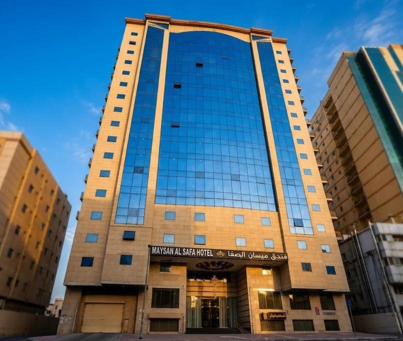 a tall building with a sign in front of it at Maysan Al Safa Hotel in Mecca