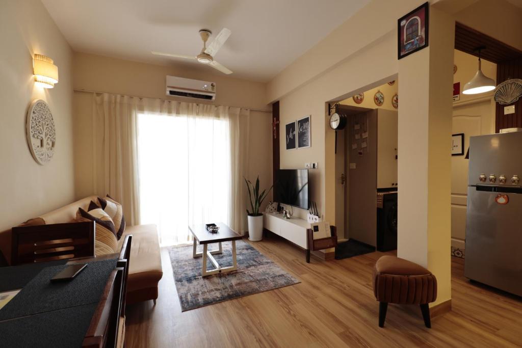 a living room with a couch and a table at Shalom in Colva