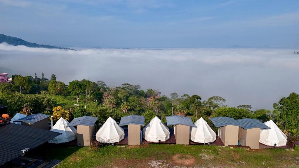 an aerial view of a group of tents in a field at Heaven Khaokho (เฮฟเว่น) in Khao Kho