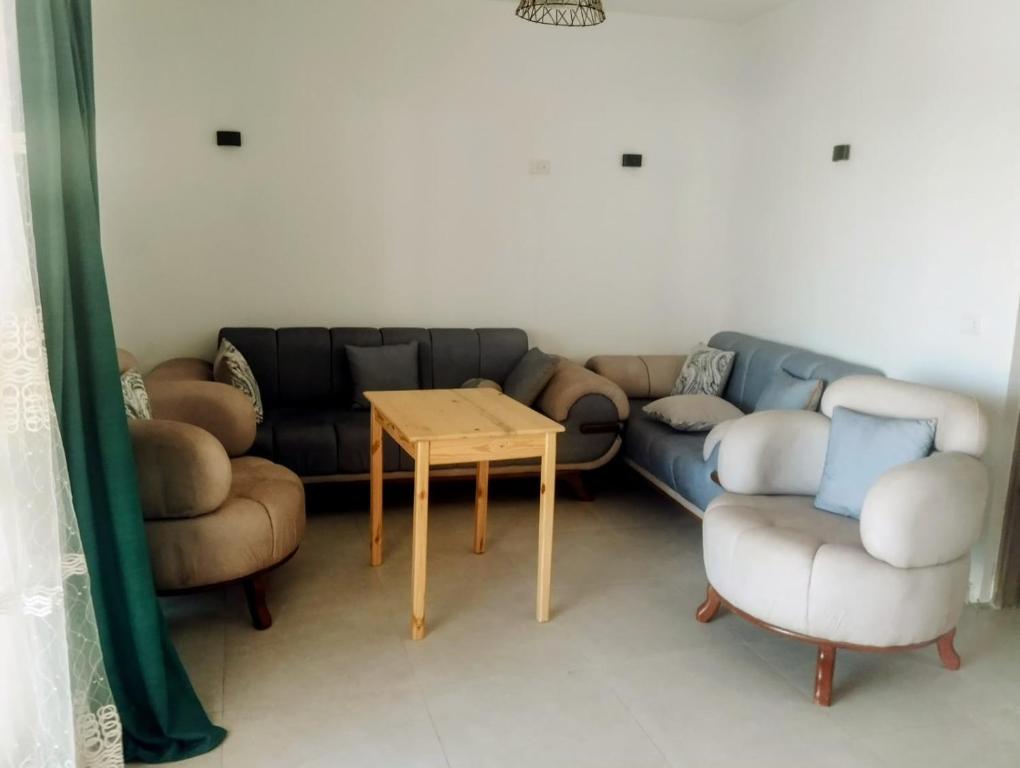 a living room with a couch and a table and chairs at Quiet place in Dahab