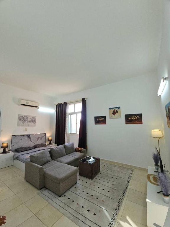 a large living room with a couch and a table at Towaya studio in Al Ain