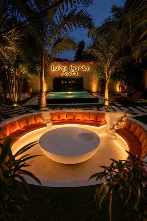 a large amphitheater with orange chairs and a fountain at Lukas Garden Accra Exclusive Resort in Accra