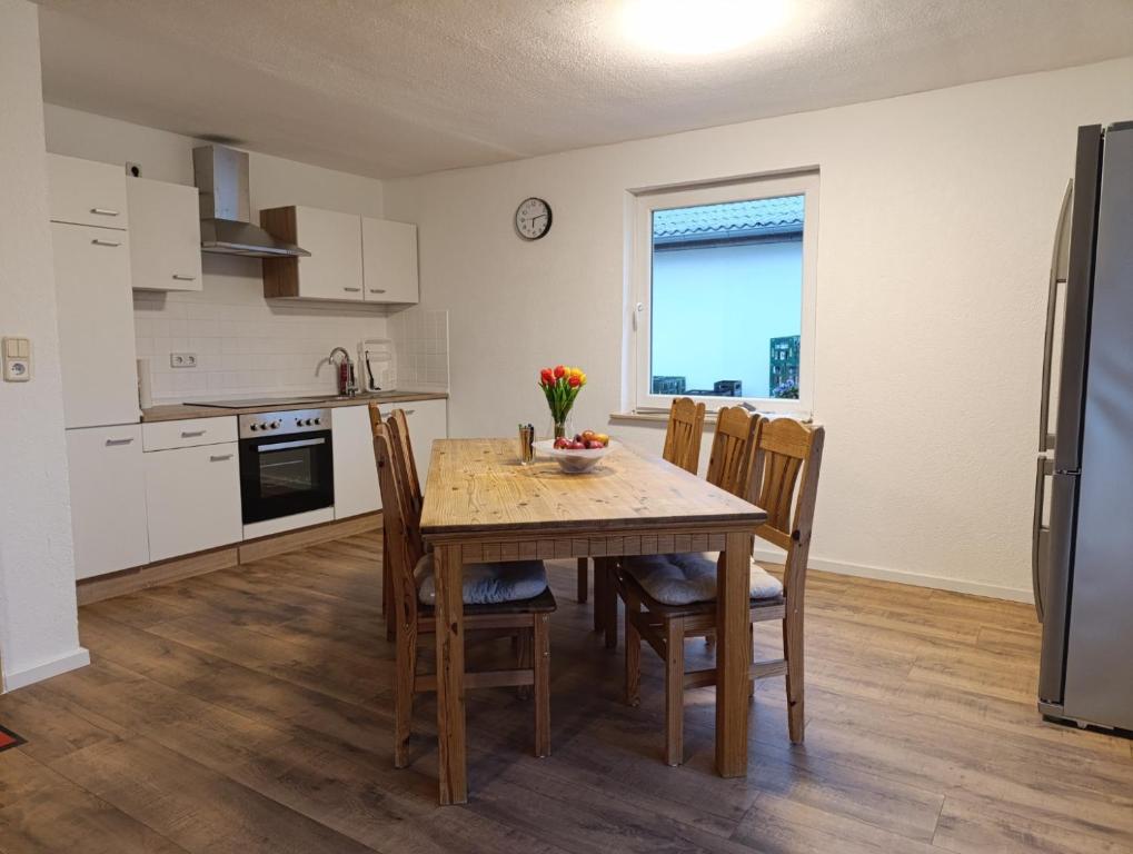 a kitchen and dining room with a table and chairs at Landhaus Leopold in Sanitz