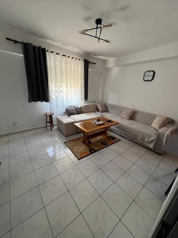 a living room with a couch and a table at Apartament 33 in Elbasan