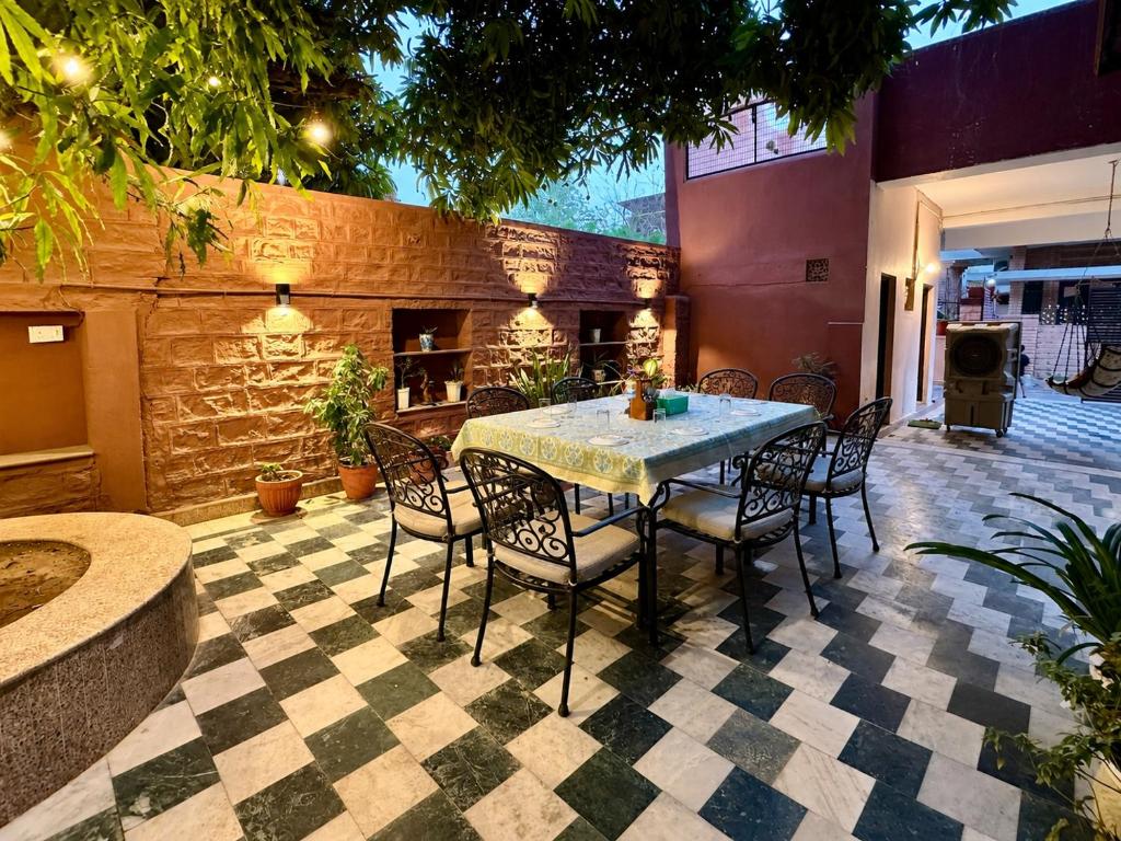 a patio with a table and chairs and a fireplace at The Mango Tree by ANAND VILLA in Jodhpur