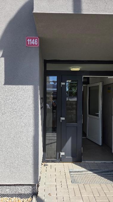 an entrance to a building with a sign on the door at Apartmán Topolová 1146 in Milovice
