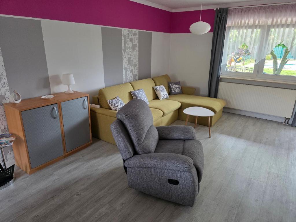 a living room with a couch and a chair at Ferienwohnung Hanni in Gräfenhainichen