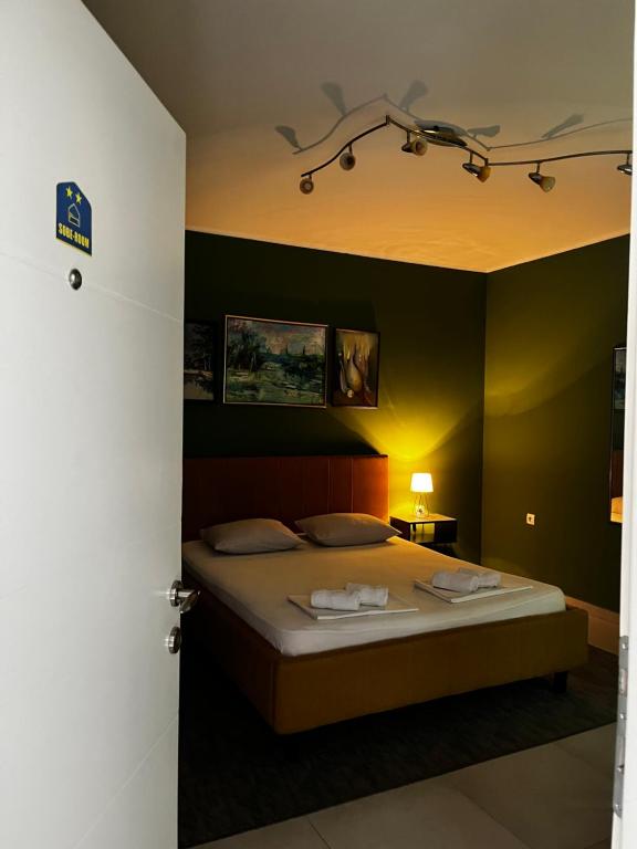 a bedroom with a bed with a black wall at Apartman Centar in Sombor