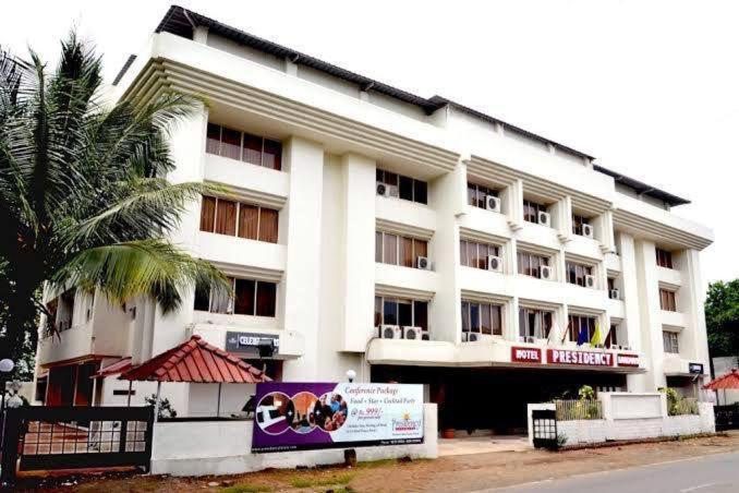 a large white building with a sign in front of it at Presidency Landmark in Daman