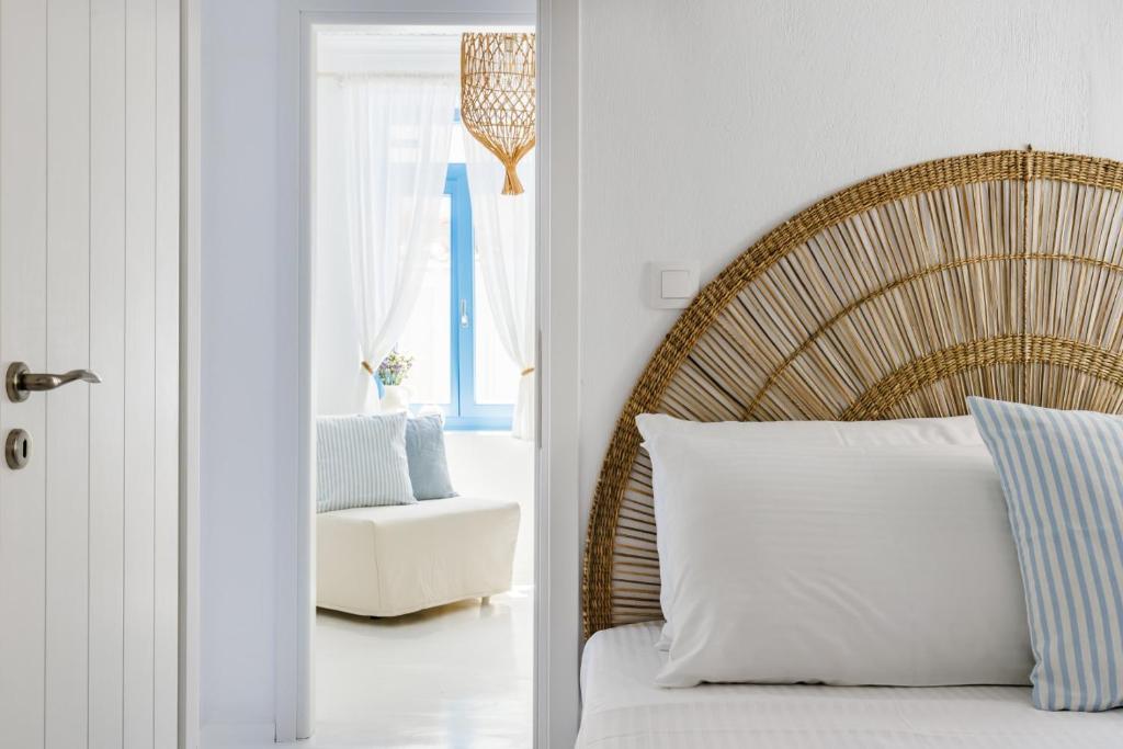 a bedroom with a bed and a chair in a room at Maison Mariel in Skopelos Town