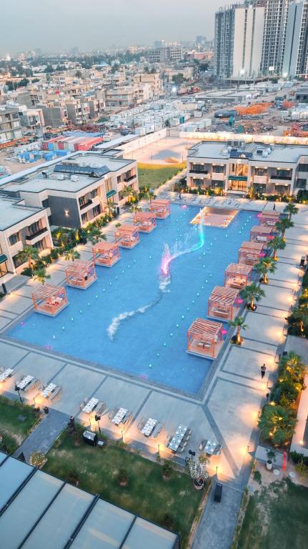 an overhead view of a large swimming pool in a city at Al- Abasly Suites in Baghdād