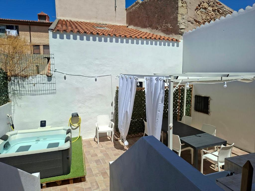 a patio with a hot tub and a table and chairs at Su ciaccu in Nulvi