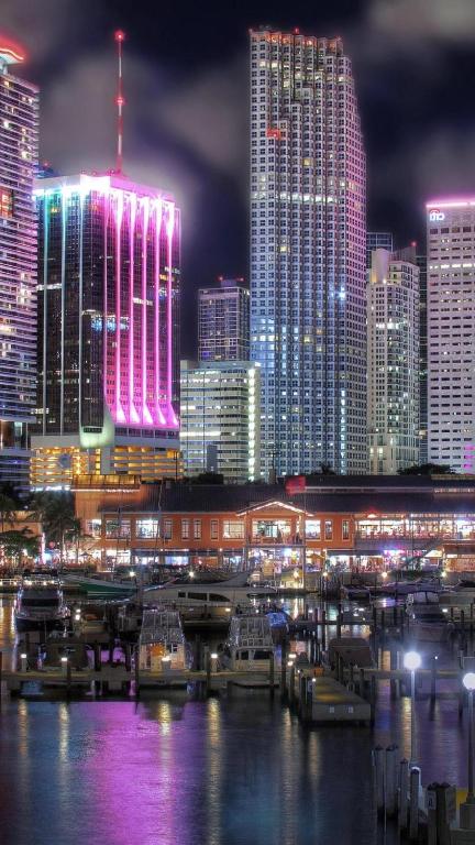 a city skyline at night with tall buildings at The Downtown Luxury Collection in Miami