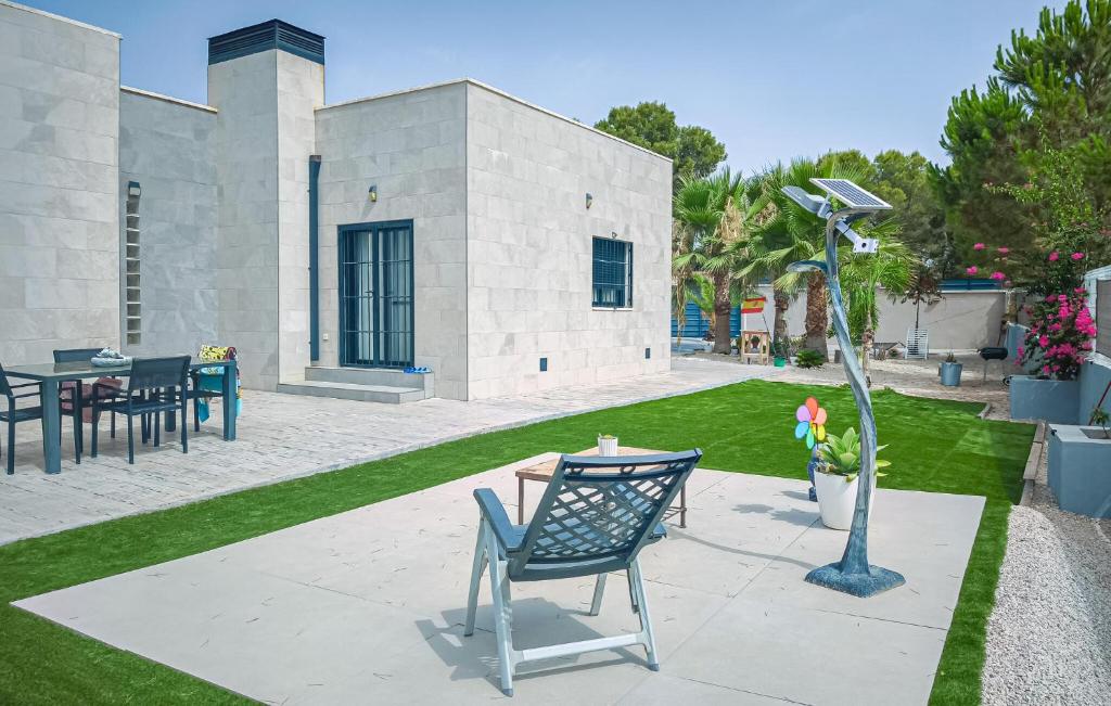 a patio with a chair and a light pole at Villa Villaplana in Fortuna