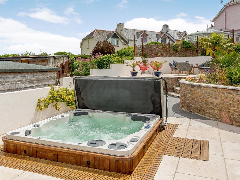 a hot tub sitting on top of a patio at Wrens Perch in Brixham