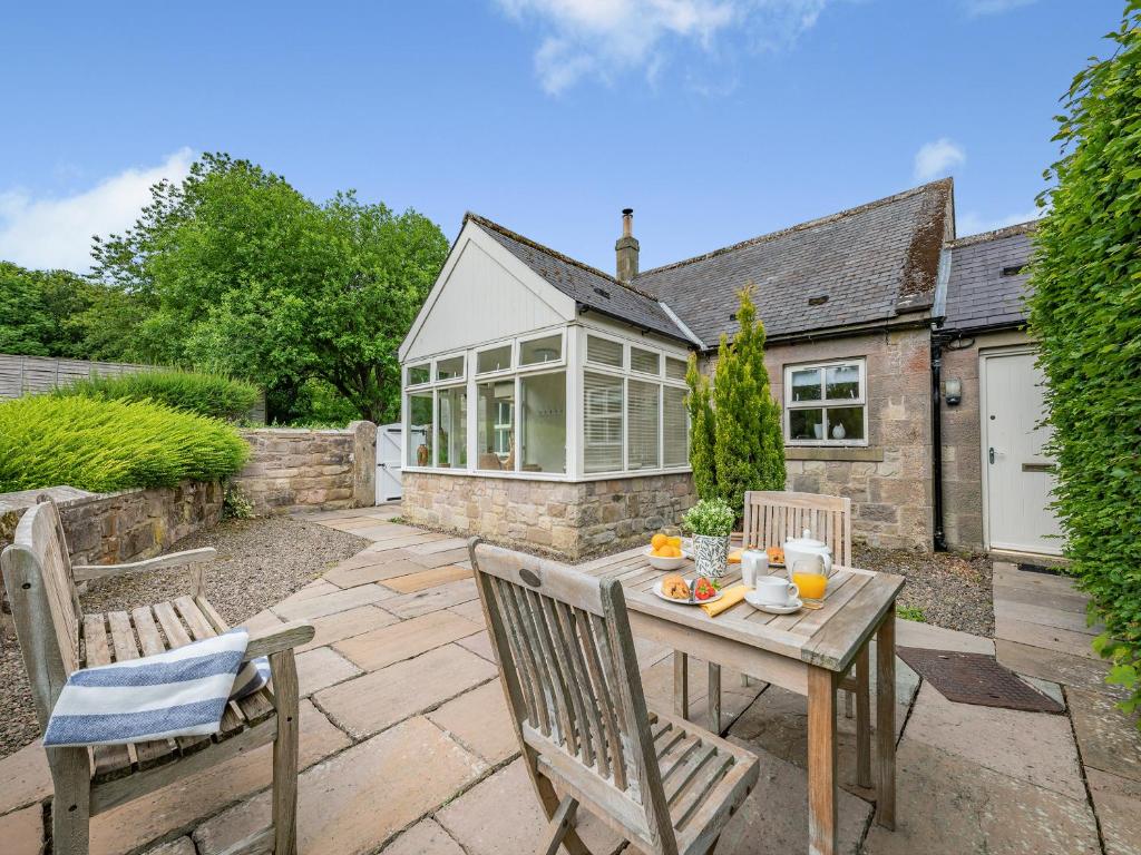 a patio with a table and chairs and a house at Fox Cover - Uk49892 in Preston