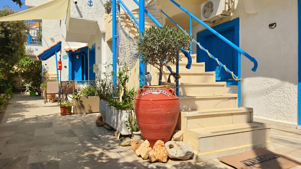 a large vase sitting on the side of a building at Michele Marie apts in Agia Pelagia