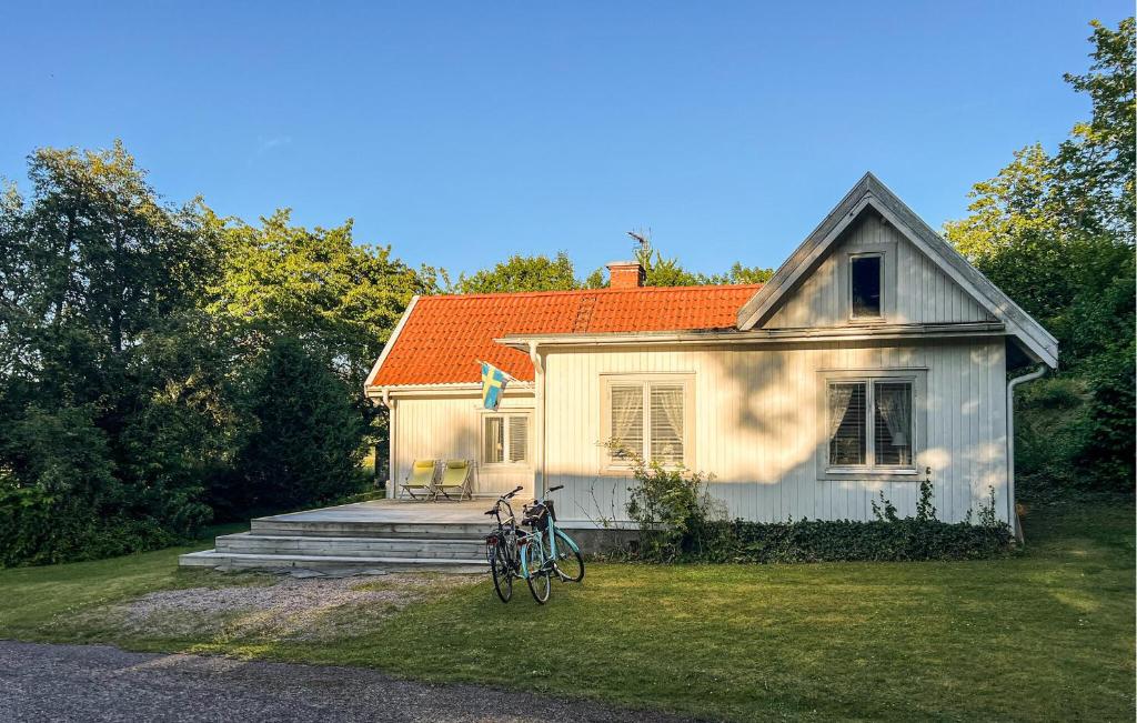 a white house with a bike parked in front of it at 2 Bedroom Lovely Home In Ödeshög in Ödeshög