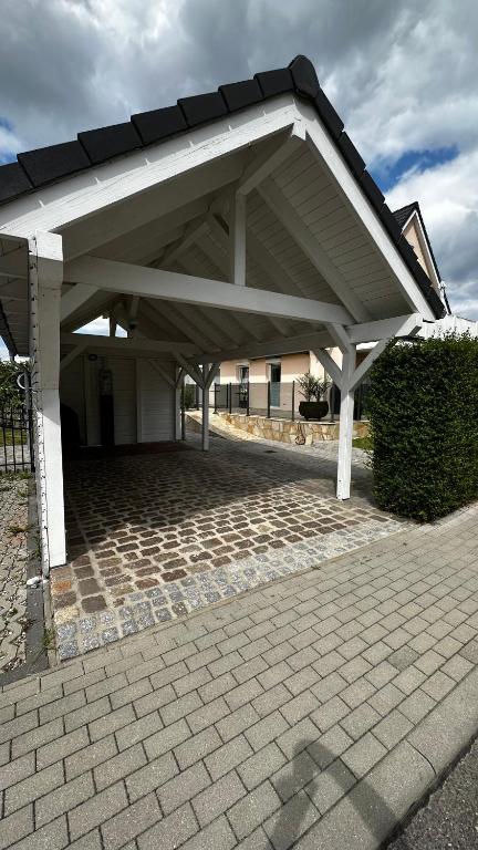 a large white pavilion with a brick patio at SONNENSEITE 2 in Laboe