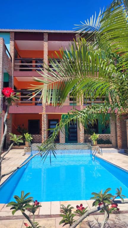a large swimming pool in front of a building at POUSADA MARINA PRAiA in Beberibe